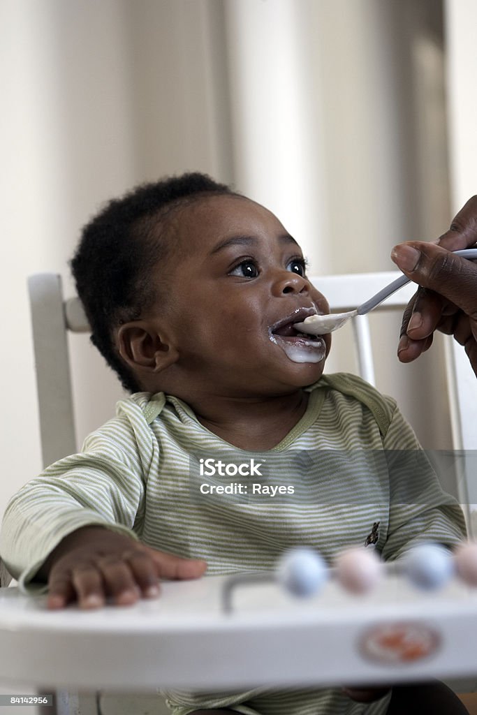 baby being fed yoghurt  Baby - Human Age Stock Photo