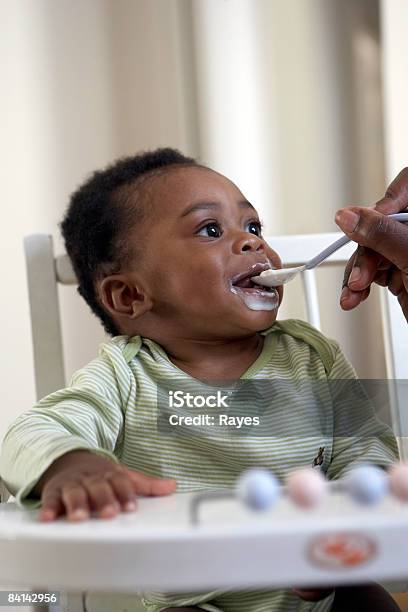Baby Being Fed Yoghurt Stock Photo - Download Image Now - Baby - Human Age, Eating, Feeding