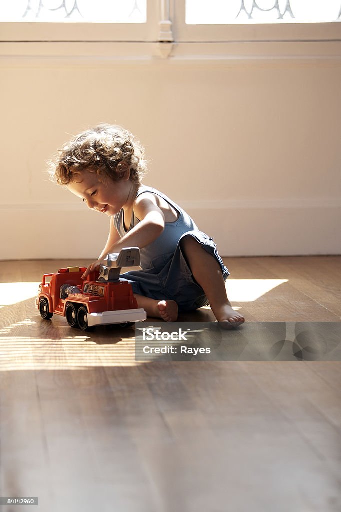 baby boy playing with toy fire engine  Playing Stock Photo