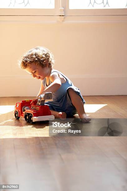 Baby Boy Playing With Toy Fire Engine Stock Photo - Download Image Now - Playing, Hardwood Floor, Toy Car