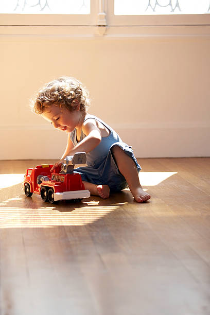niemowlę chłopiec gra z zabawka wóz strażacki - one baby boy only zdjęcia i obrazy z banku zdjęć
