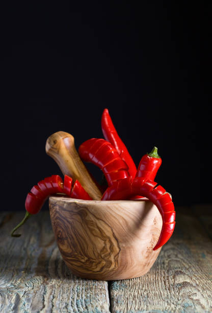 istock Red chili pepper in wooden mortar . 841441540