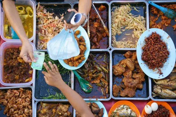 Buying food.Variety of delicious Malaysian home cooked dishes sold at street market stall in Kota Kinabalu Sabah  from top angle view.