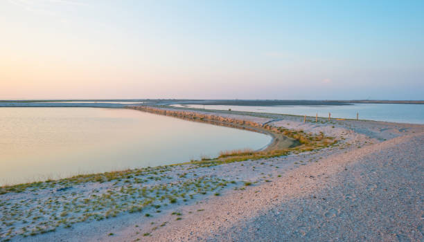 istock Artificial island under construction in a lake at sunset in summer 841446246