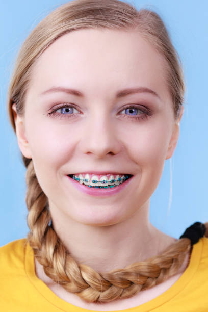 istock Woman showing her teeth with braces 841448512