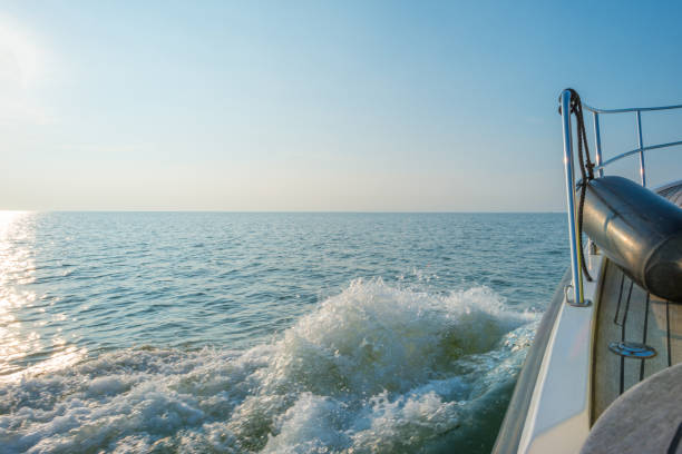 istock Boat sailing on a lake at sunset in summer 841449172