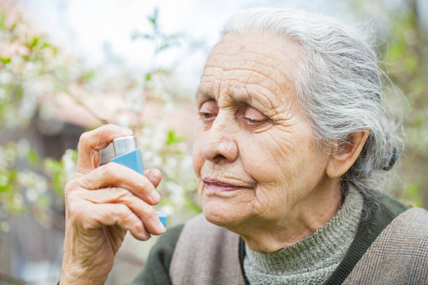 istock Elderly woman having asthma attack, holding a bronchodilator 841453480