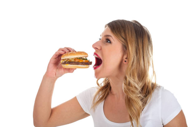 istock Pretty woman eating a delicious hamburger 841453844