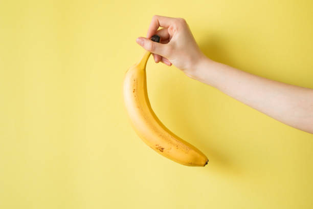 istock Human Hand Holding Banana Fruit Nutrition Concept 841456828
