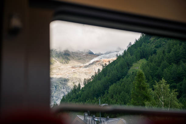istock Mountain panorama with glacier framed through train windows in sunny summer day 841457338