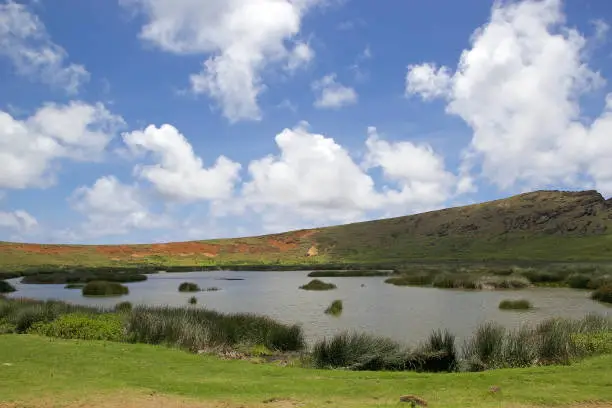 Crater lake at the Rano Raraku archaeological site, Easter Island, Rapa Nui, Chile. Easter Island is a Chilean island in the southeastern Pacific Ocean. It is famous for its 887 extant monumental statues called moai