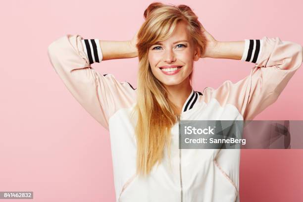 Varsity Girl Stock Photo - Download Image Now - One Woman Only, Colored Background, Blond Hair