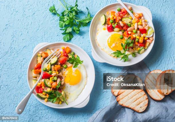 Breakfast Vegetable Hash With Fried Eggs On A Blue Background Top View Healthy Food Concept Stock Photo - Download Image Now