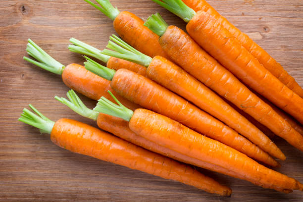 istock Fresh carrots on the wooden background. 841470692