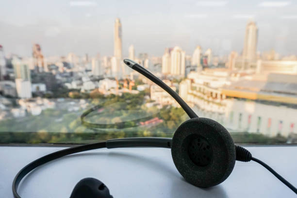 istock close up black headset on table with city view backdrop 841470776