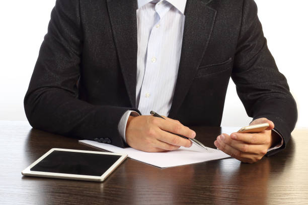 istock manager at desk writes on paper phone isolated on white background. 841472088