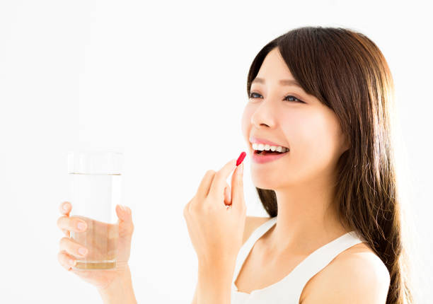 smiling young woman eating the pill