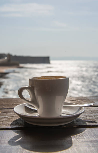 istock Cup of coffee on sea background 841478244