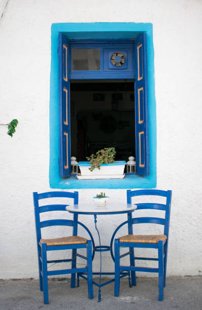istock Two chairs in front of a window 841478878
