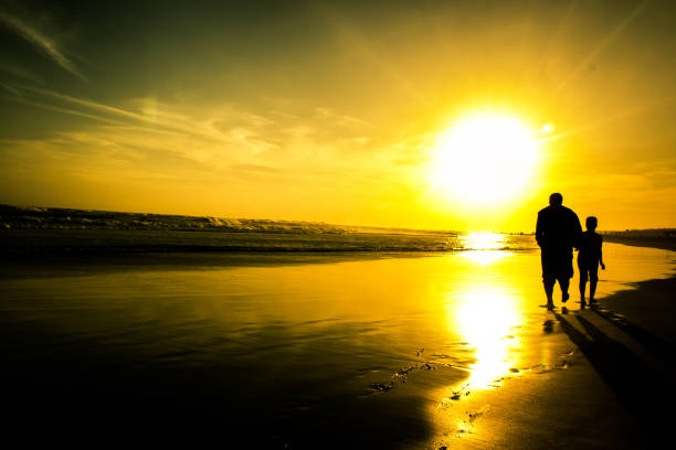 istock father and son walk towards the sun 841481942