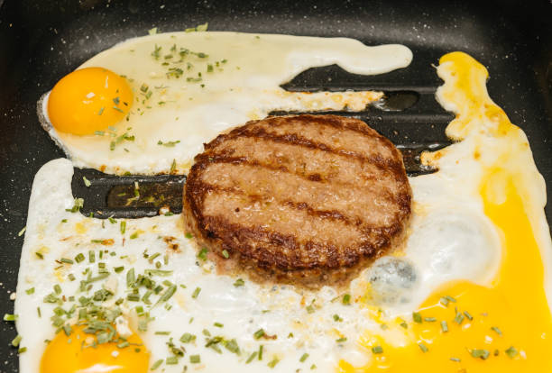 istock Preparing delicious burger with egg at home 841482414