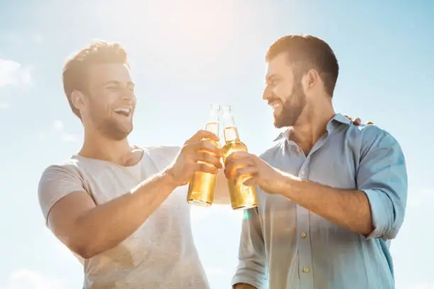 Group of people having barbecue party drinking beer