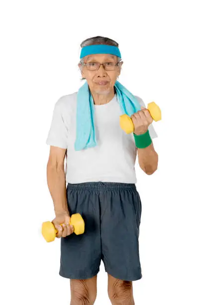 Portrait of an elderly man exercising with two dumbbells, isolated on white background