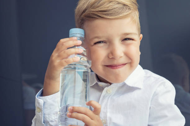 istock Happy child with water bottle. 841495318