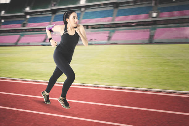 istock Young woman running on stadium 841501860