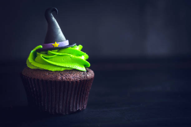 Witch hat cupcakes Witch hat cupcake on dark background with blank space halloween cupcake stock pictures, royalty-free photos & images