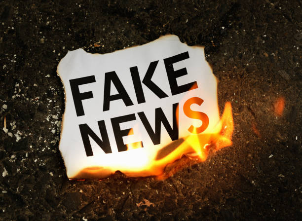 istock 'Fake news' document goes up in smoke 841502708