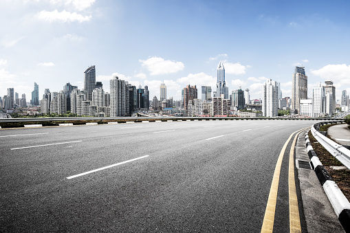 empty asphalt road and cityscape of shanghai in blue sky