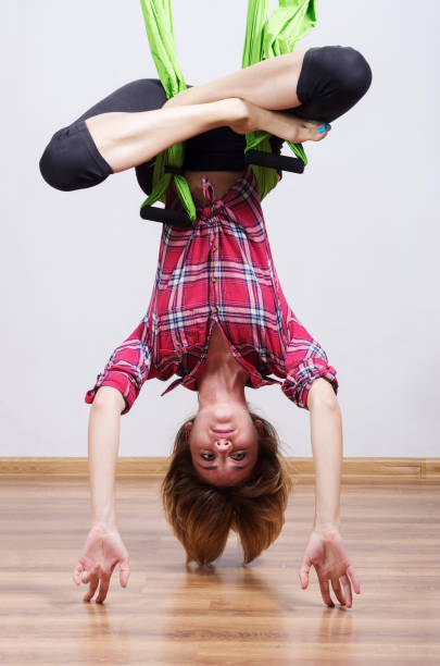 istock The girl performs exercises in a hammock for yoga 841515092