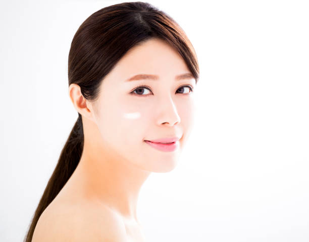 istock beautiful woman face with cosmetic cream 841515146