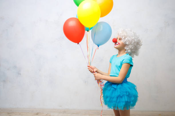 little girl wearing clown costume isolated on white - entertainment clown child circus imagens e fotografias de stock