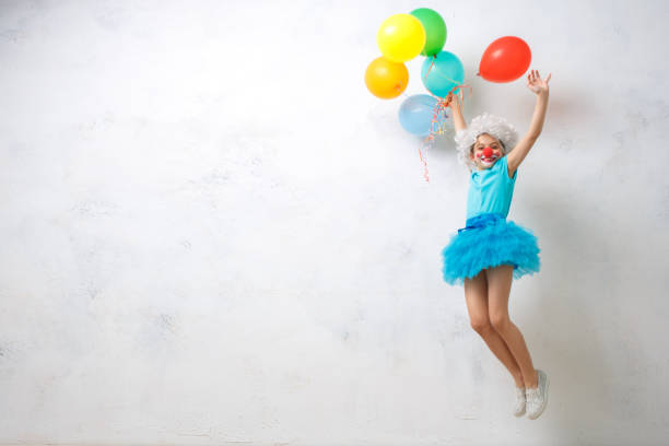 little girl wearing clown costume isolated on white - entertainment clown child circus imagens e fotografias de stock