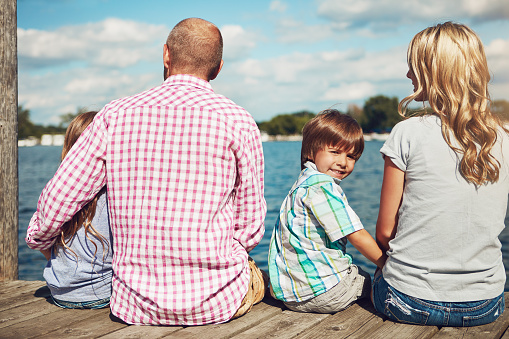 Shot of a family on a pier while out by the lake