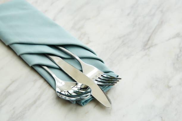 istock spoon and fork tied on a blue napkin on marble 841534246