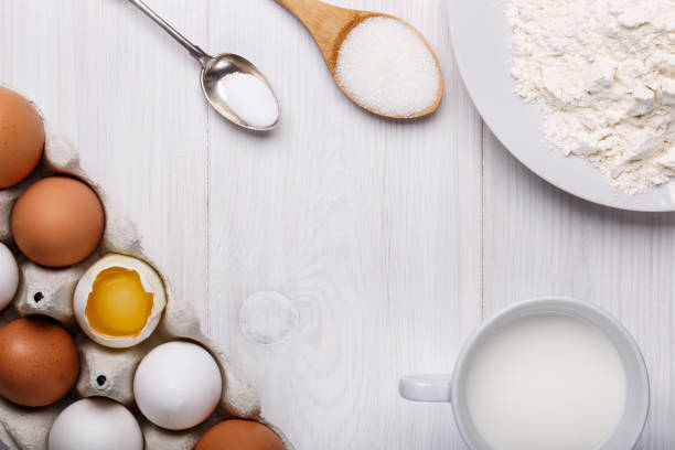 istock Ingredients for making pancake dough (eggs, flour, milk, sugar, salt) on white wooden table. Top view. Copy space. 841539222