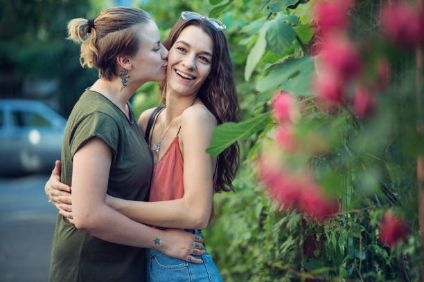 istock Women kissing and hugging 841544344