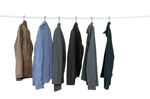 Collection of men's long sleeve shirts hanging on the clothes line isolated on white background with clipping path, lifestyle, beauty and fashion concept.