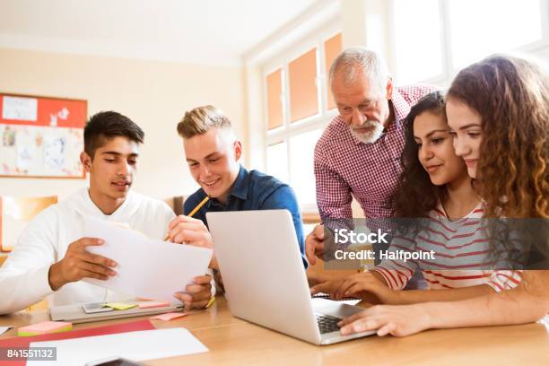 High School Students And Teacher With Laptop Stock Photo - Download Image Now - Teacher, High School Student, Classroom