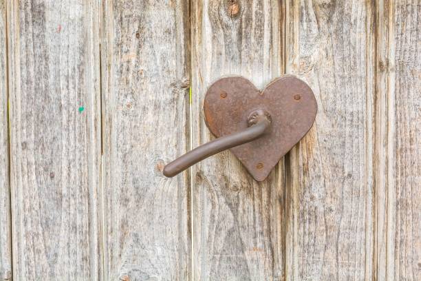 istock Heart shaped rusty door handle on wooden gate 841551600