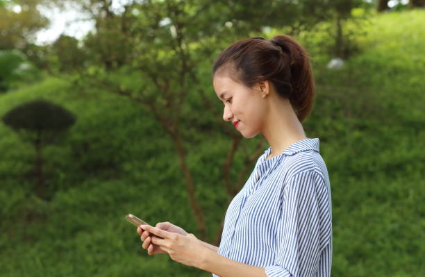 istock Young girl using smartphone in Vietnam 841554448