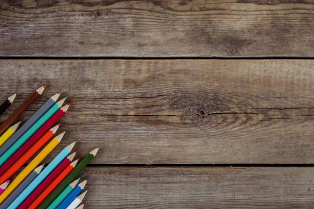 back to school concept background with colored pencils on wooden table, flat lay - ravena imagens e fotografias de stock