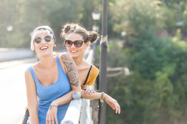 istock Girls having fun and talking on a bridge 841561958