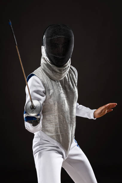 istock Woman fencer in attacking pose 841565088