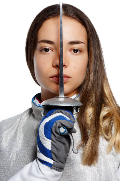 Young Woman fencer holding the sword in front of her stock photo