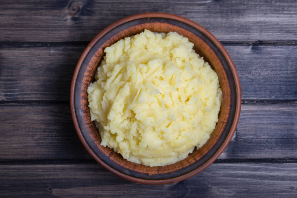 istock Mashed potatoes in a plate on the wooden table 841567652