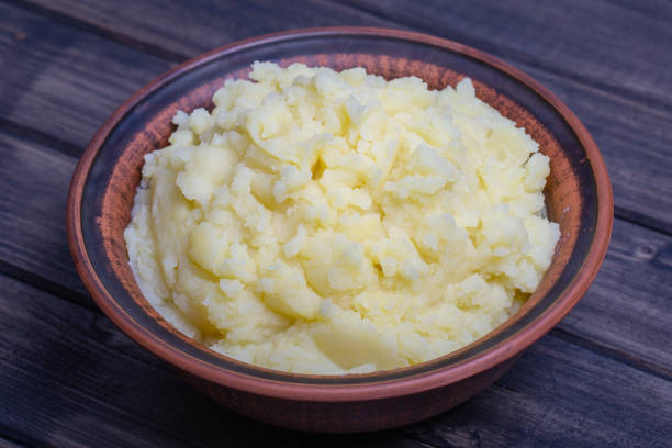 istock Mashed potatoes in a plate on the wooden table 841567668